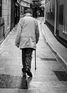 Elderly Irishman, cane, grafton street, dublin, ireland, black and white, walking away, view from behind 